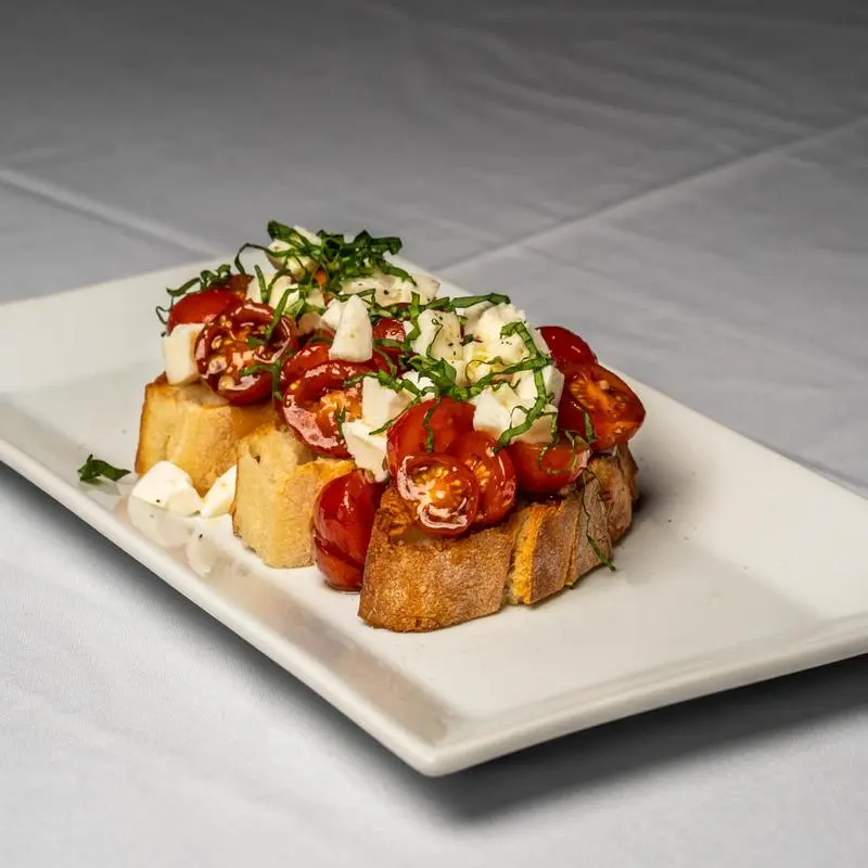 Bruschetta with marinated tomatoes and basil at Chef's Roma Kitchen